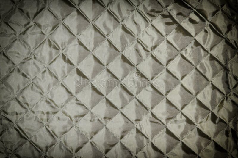 Texture, black quilted fabric close up. Blank background for layouts with vignette. Texture, black quilted fabric close up. Blank background for layouts with vignette.